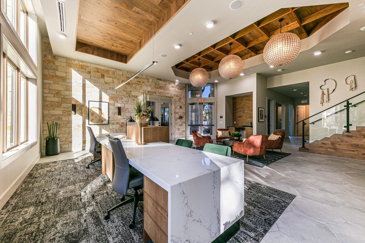 Leasing desks facing lobby and waiting area with armchairs