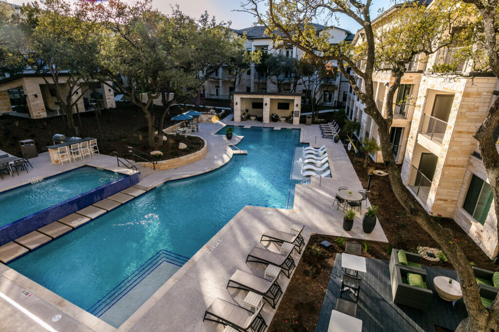 Alternate view of resort style pool with ample seating and covered lounge areas
