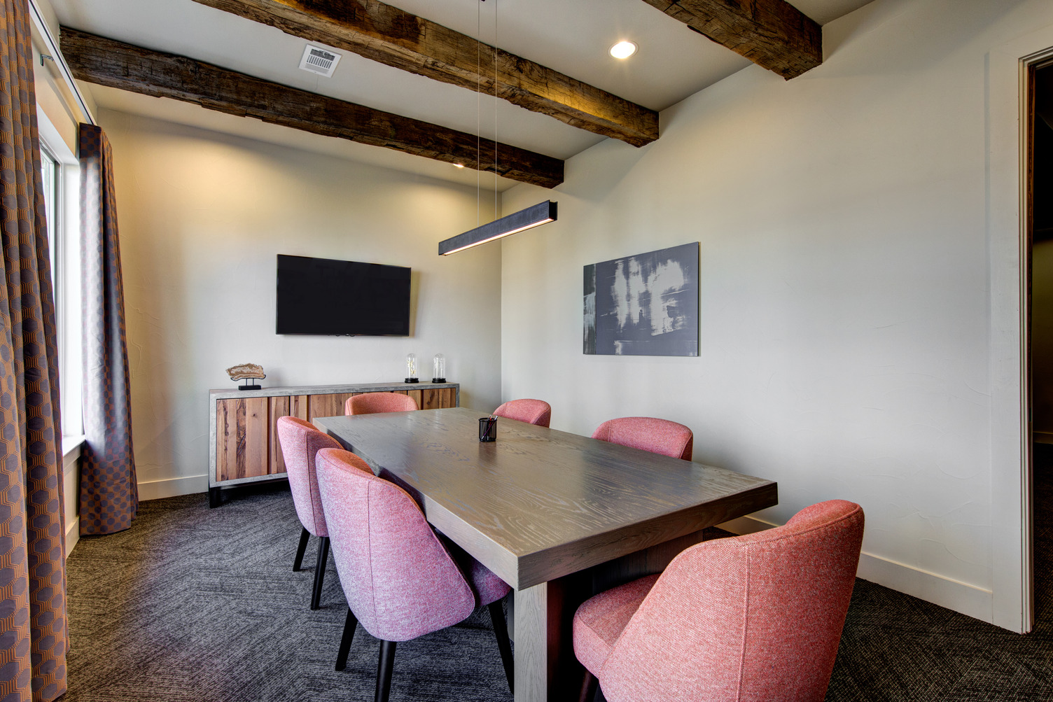 Conference room with large meeting table and wall mounted TV