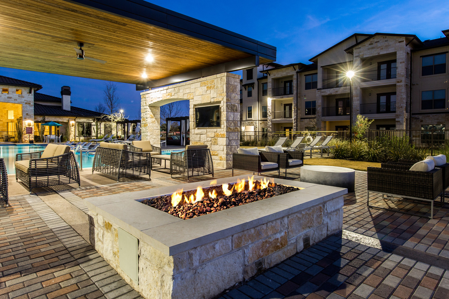 Fire pit and outdoor seating area near pool deck