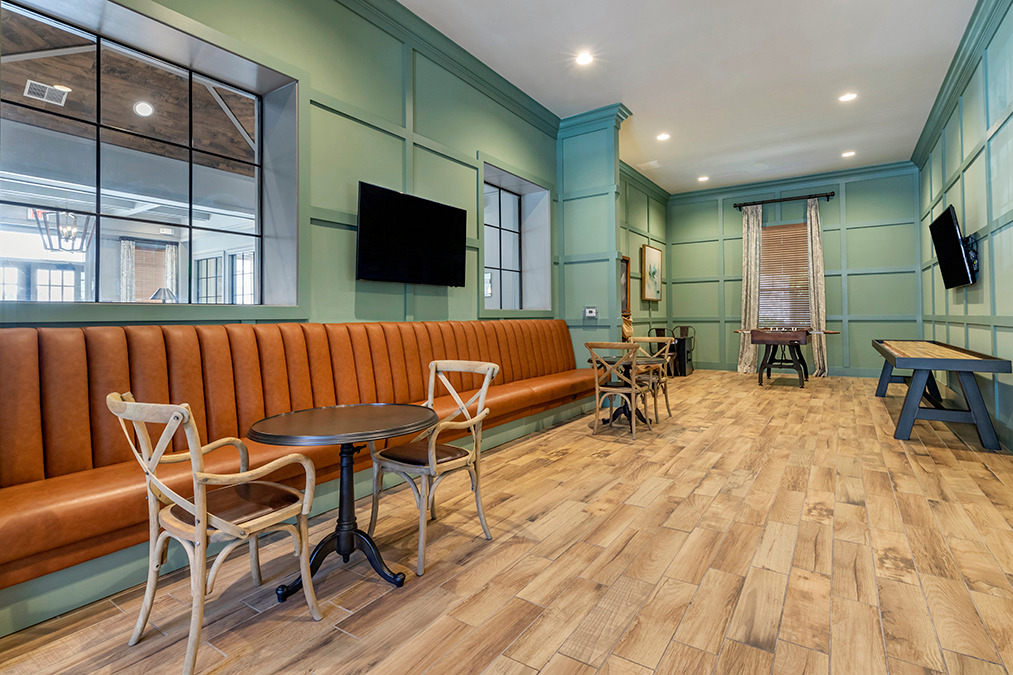 Clubroom and lounge with table seating, couch seating, and shuffleboard