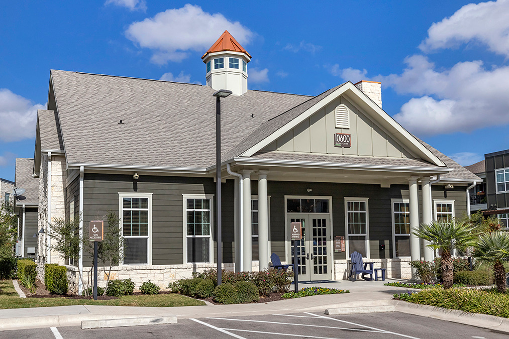 Community entrance with minimalist courtyard and brick exterior