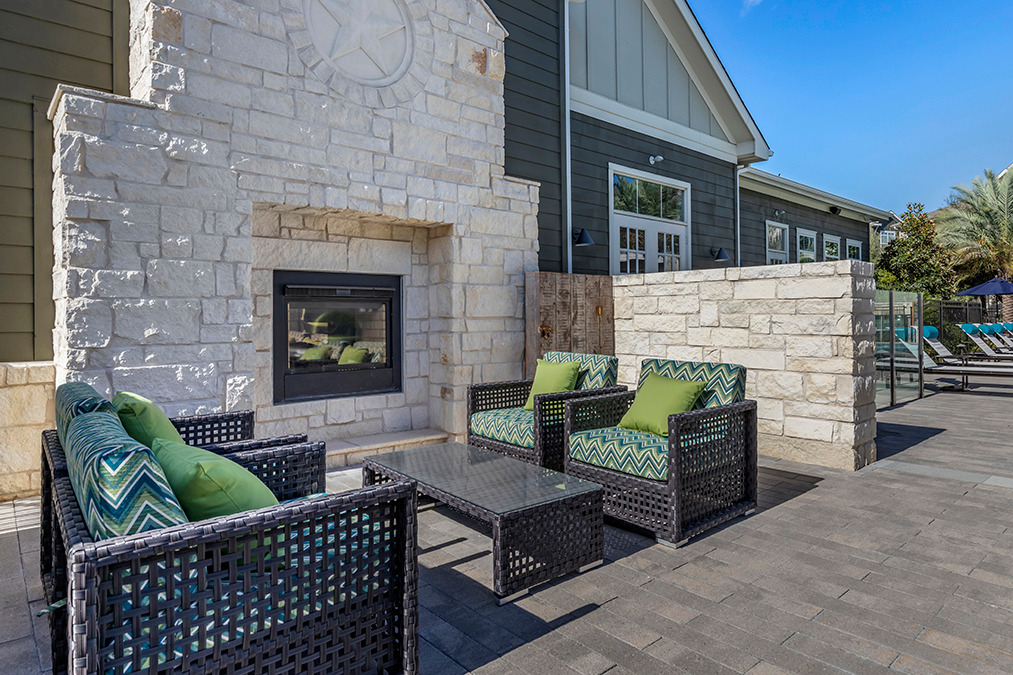 Outdoor view with green outdoor chushined chairs and fire pits