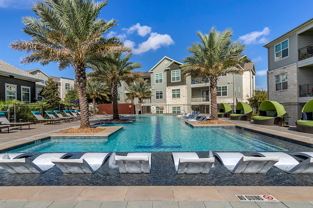 View of pool deck and courtyard with lounge seating