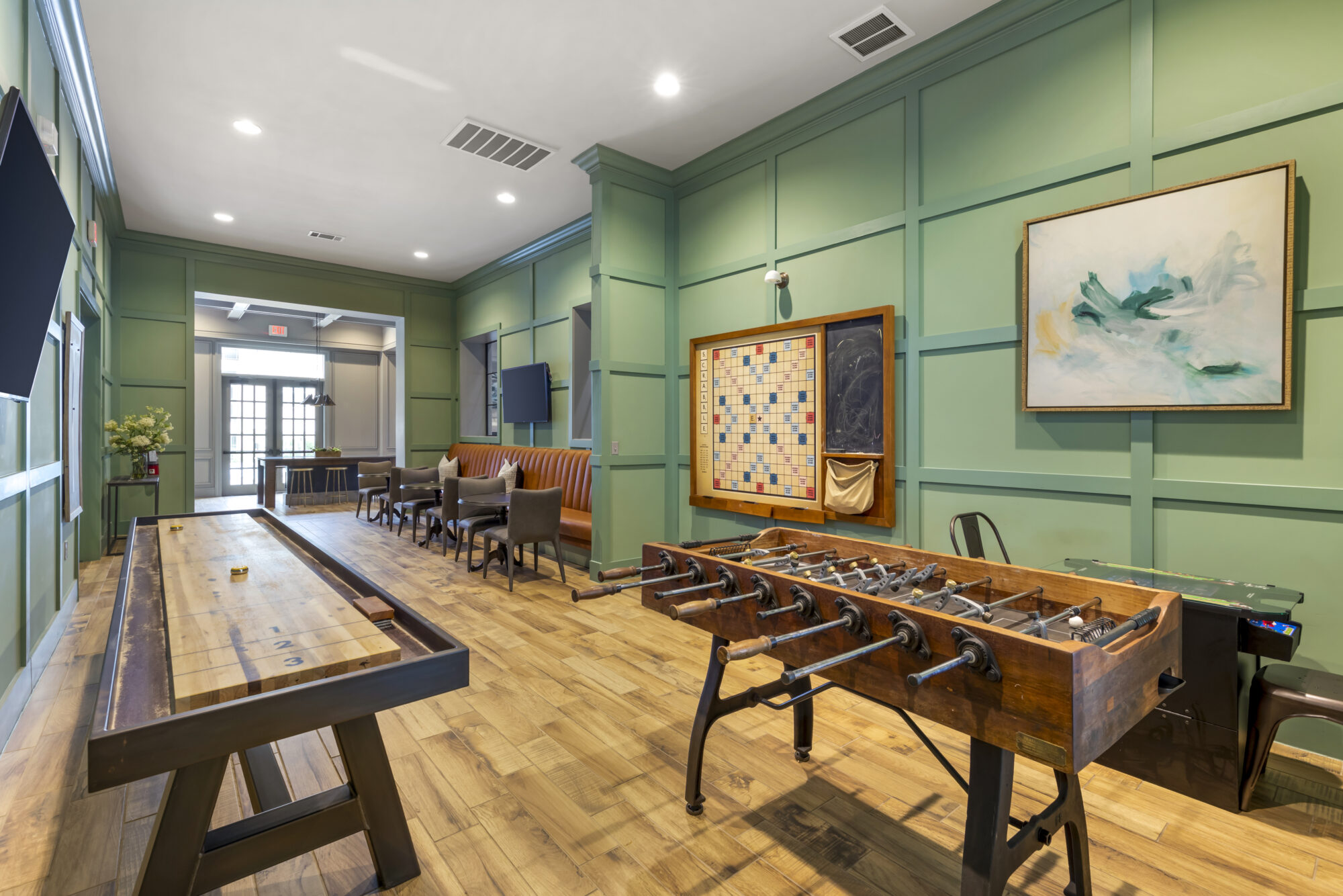 Clubroom and lounge with shuffleboard and foosball table